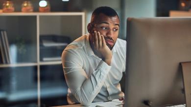 
		Man sitting tired at his desk
	